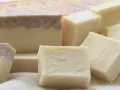 Barras de jabón artesanal, algunas con remolinos morados y verdes, otras lisas. Un ejemplo de qué es el jabón de castilla, puro y natural.