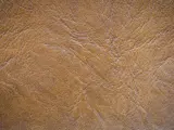 Textura de serraje marrón, que es un tipo de cuero con un acabado rugoso y natural, ideal para calzado o accesorios.