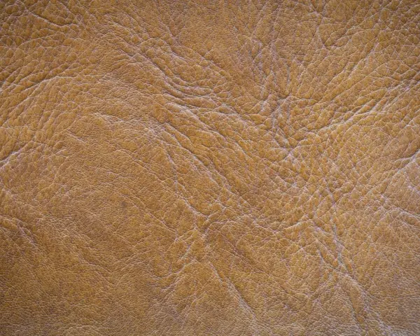 Textura de serraje marrón, que es un tipo de cuero con un acabado rugoso y natural, ideal para calzado o accesorios.