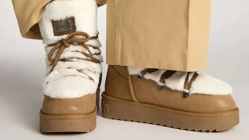 Botas de invierno marrones con forro de pelo blanco y cordones. Perfectas para limpiar y mantenerlas impecables.